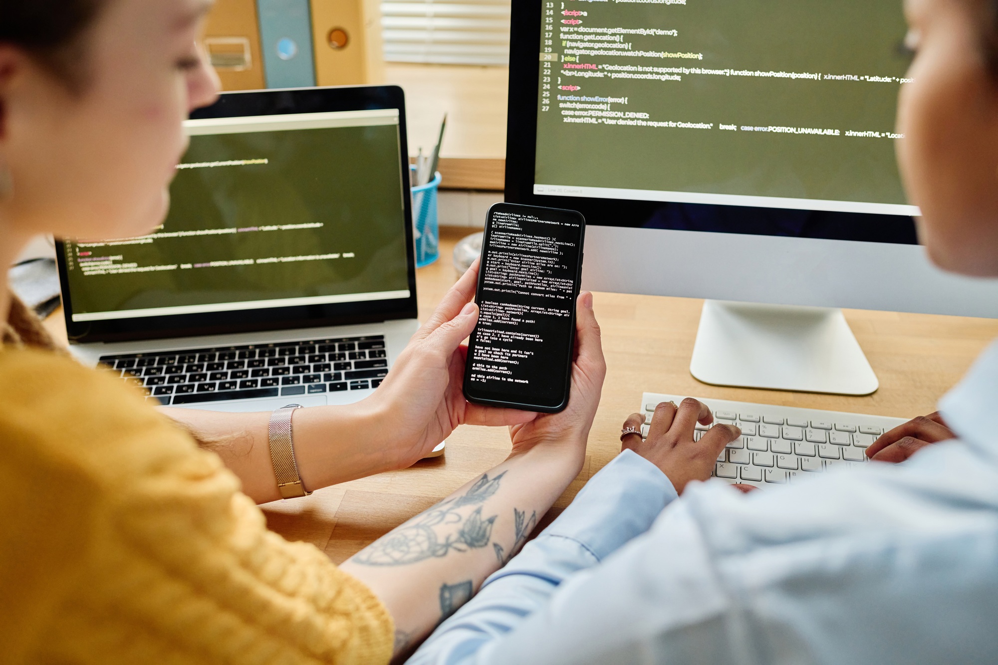 Colleagues writing security codes in team